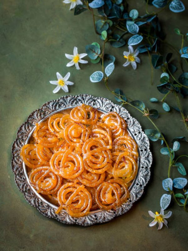 Special indian sweet jalebi or jilabi, jeelebi, and jilapi served in dish isolated on dark background top view
